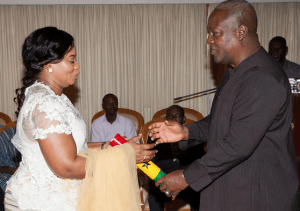 Mrs. Osei (left) being sworn in by the President, John Mahama
