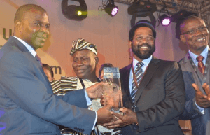 Dr Oko Vanderpuije (right) receiving the Accra award from President Eduardo dos Santos.