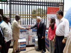 Bhagwan Khubchadani (Right), Chairman of the Melcom Group, presenting the items to Ashim Morton, Managing Partner of the Millennium Marathon 