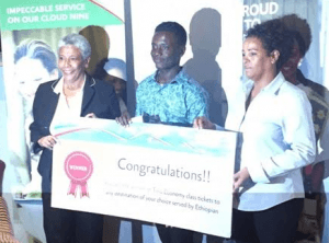 Nii Adjaidoo (middle) receiving the prize from the Ethiopian Ambassador (left) and Ethiopian Airlines Ghana Area Manager(right)