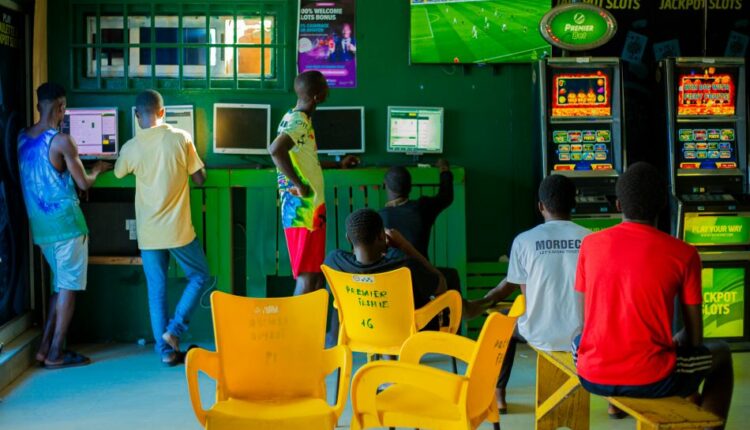 Young men betting in a shop in Accra