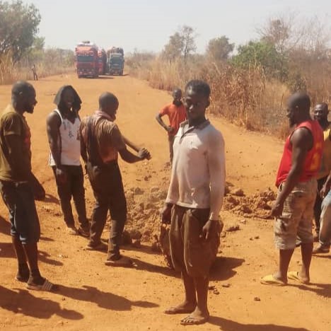 Drivers travelling between Ghana and Burkina-Faso patch highway with hands